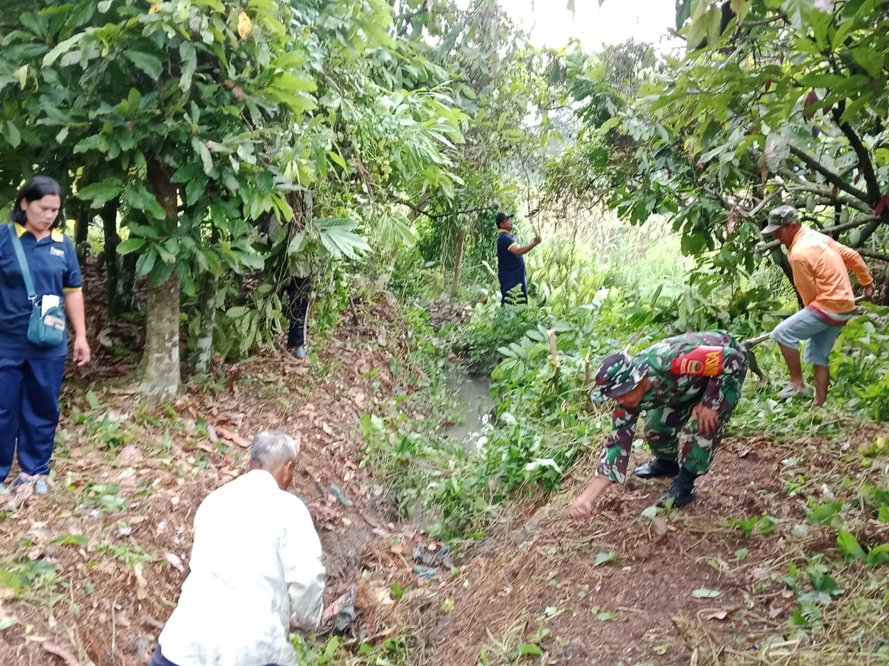  Babinsa Bantu Warga Gotong Royong Bersihkan Saluran Irigasi